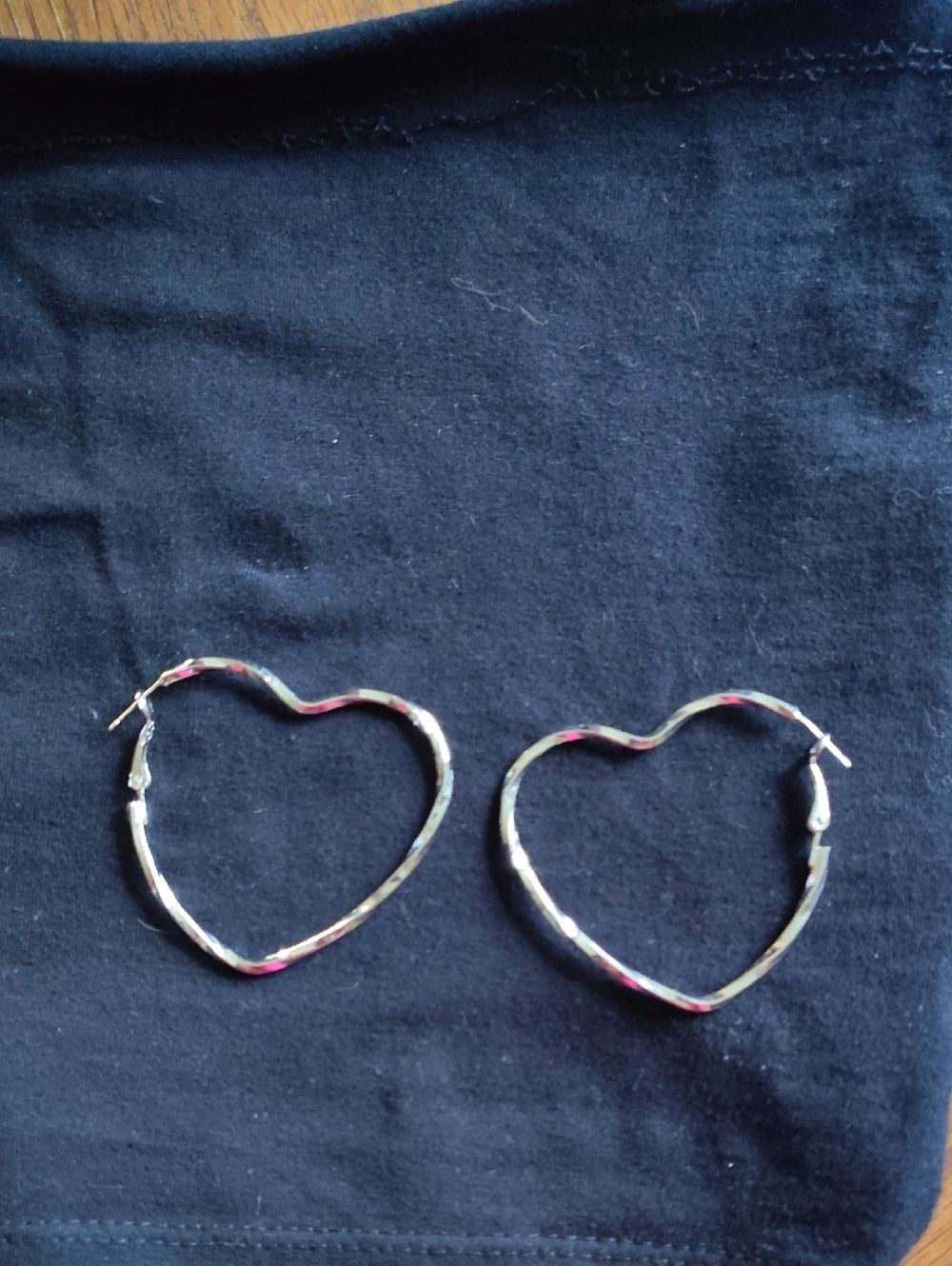 Heart-Shaped Silver Hoop Earrings.